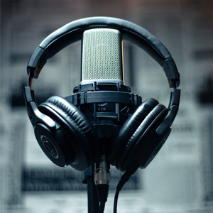 Black headphones and a recording microphone